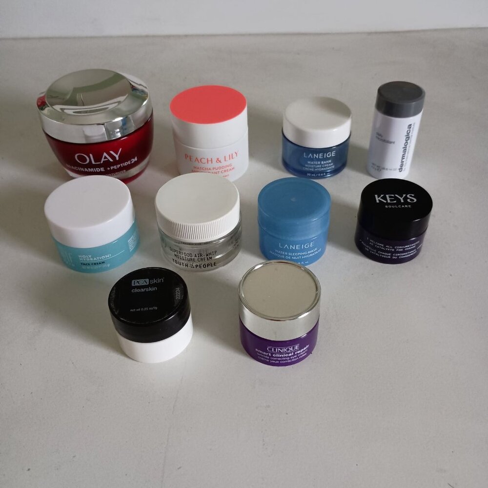 10 empty skincare containers from various brands